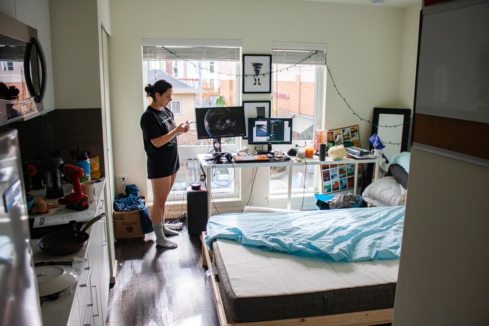 woman standing near computer desk