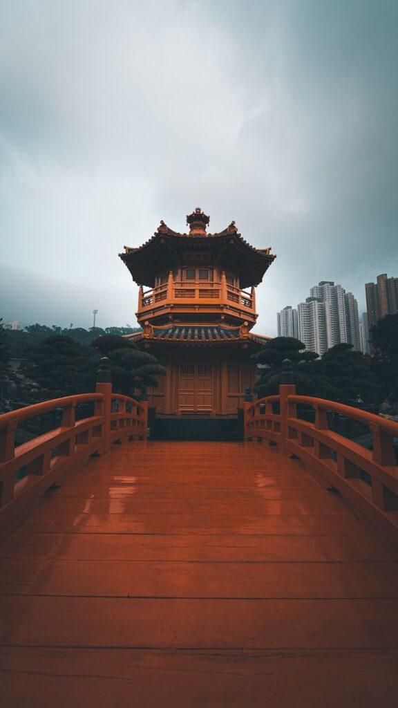 a wooden bridge with a building in the background